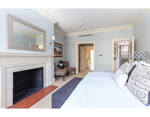 5 Charles River Square Boston, MA 02114 - Photo 15 of 21 a bedroom with a bed and a fireplace