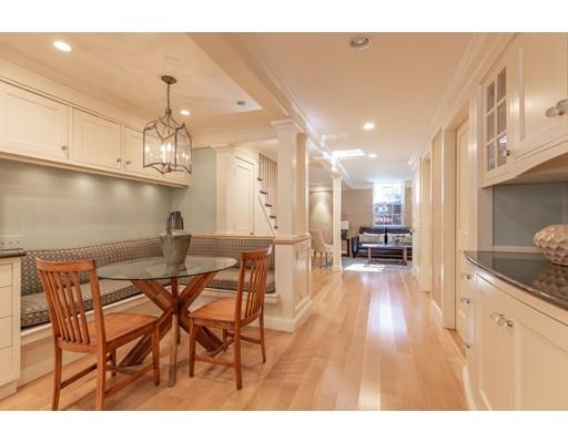 5 Charles River Square Boston, MA 02114 - Photo 5 of 21 a open kitchen with stainless steel appliances kitchen island granite countertop a table and chairs in it