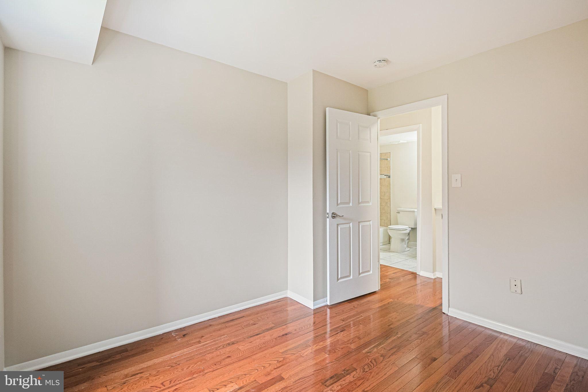 9304 Canterbury Riding, Unit 21 Laurel, MD 20723 - Photo 11 of 29 a view of an empty room with wooden floor