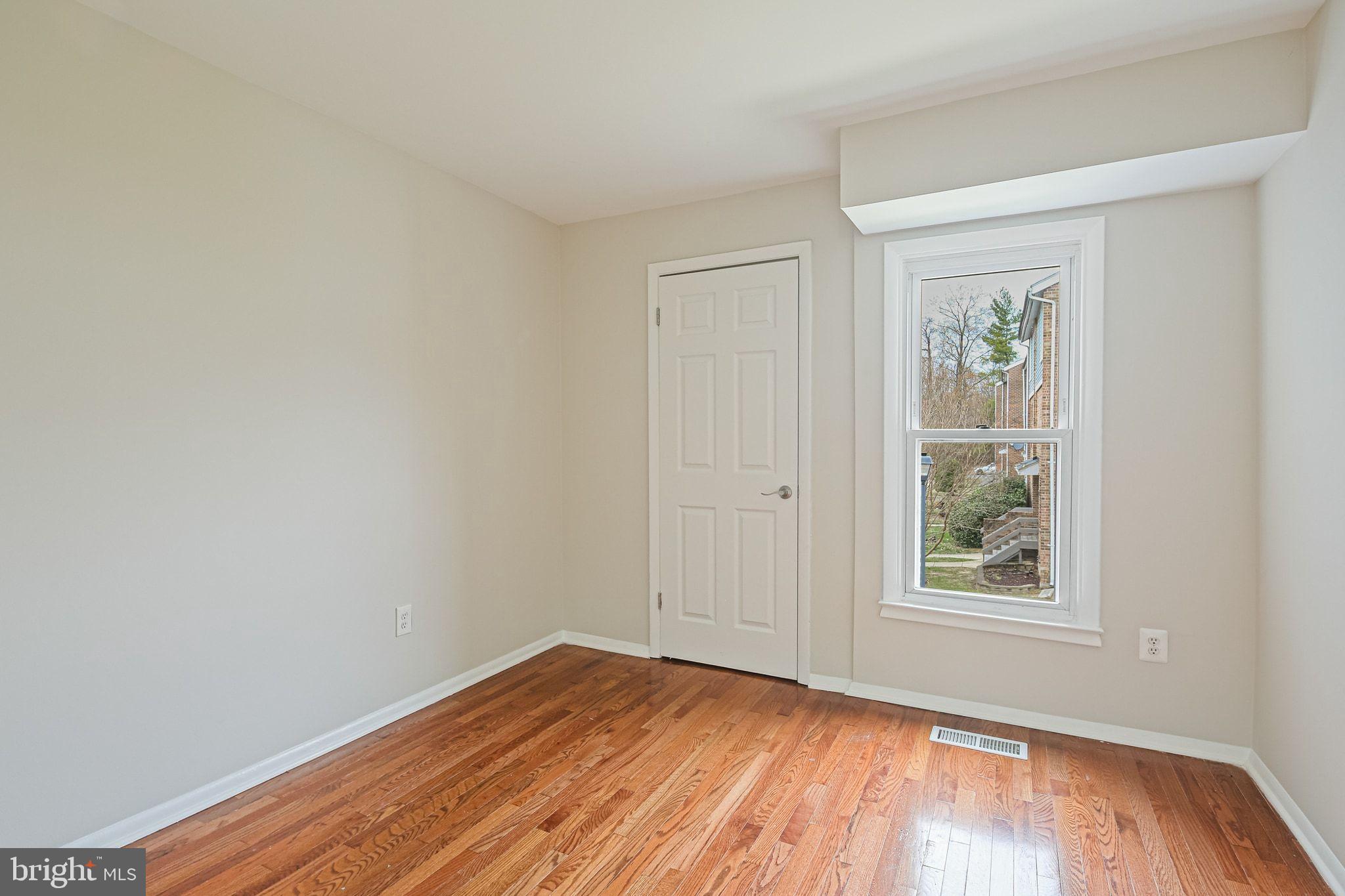 9304 Canterbury Riding, Unit 21 Laurel, MD 20723 - Photo 12 of 29 a view of an empty room with wooden floor and a window