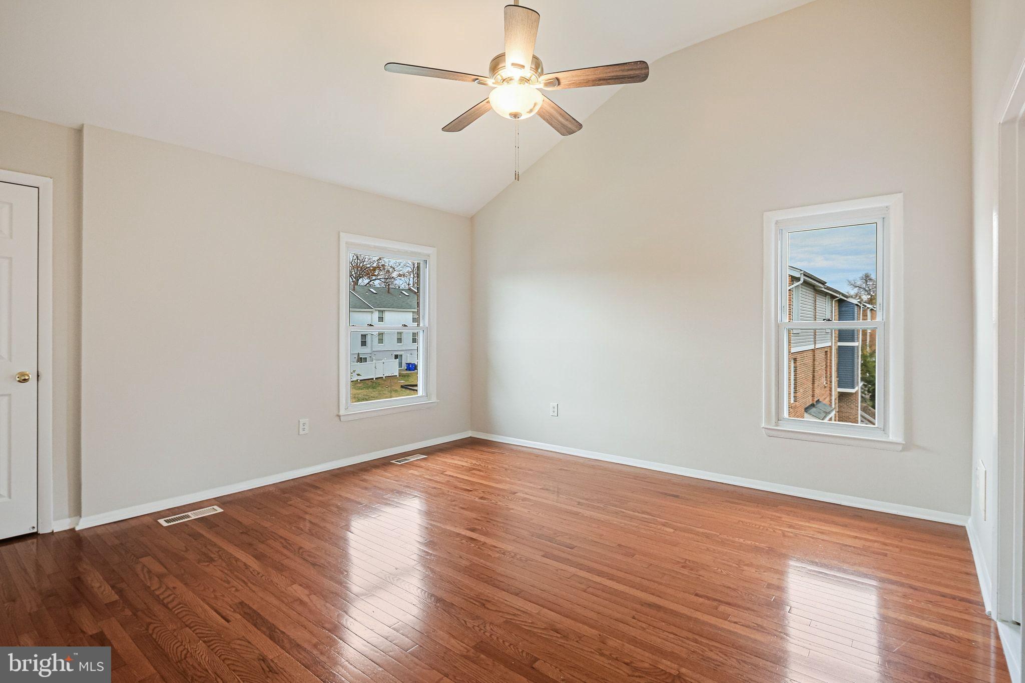 9304 Canterbury Riding, Unit 21 Laurel, MD 20723 - Photo 17 of 29 a view of an empty room with wooden floor and a window