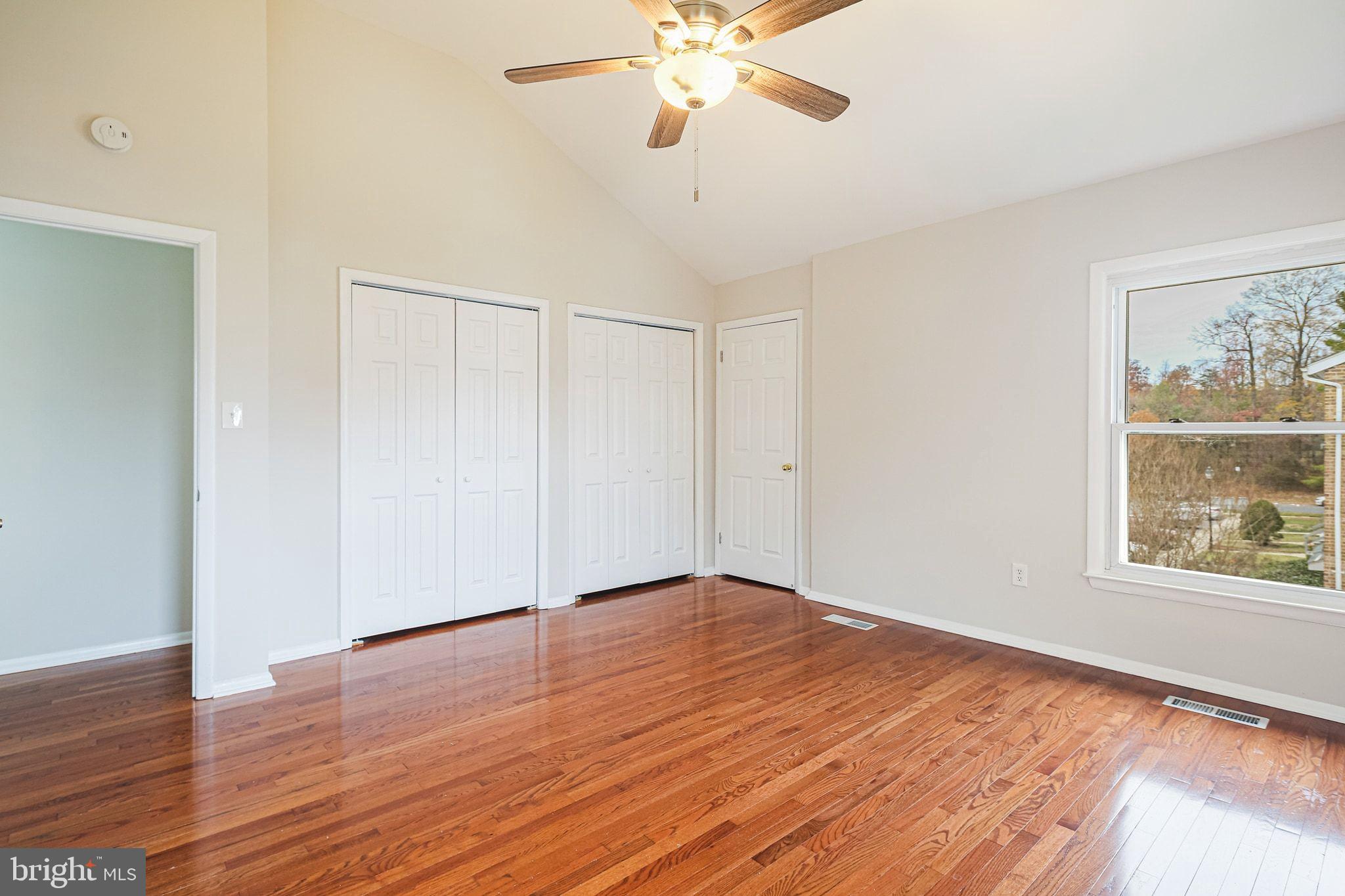 9304 Canterbury Riding, Unit 21 Laurel, MD 20723 - Photo 19 of 29 a view of an empty room with wooden floor and a window
