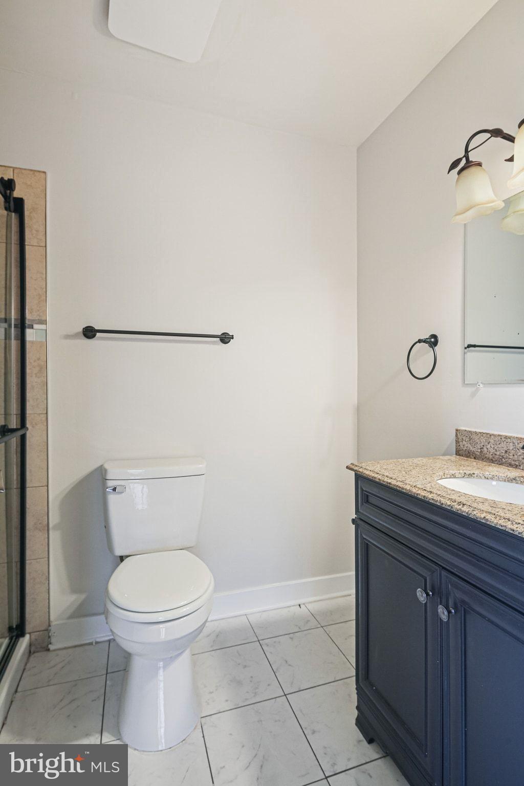9304 Canterbury Riding, Unit 21 Laurel, MD 20723 - Photo 20 of 29 a bathroom with a granite countertop toilet and a sink