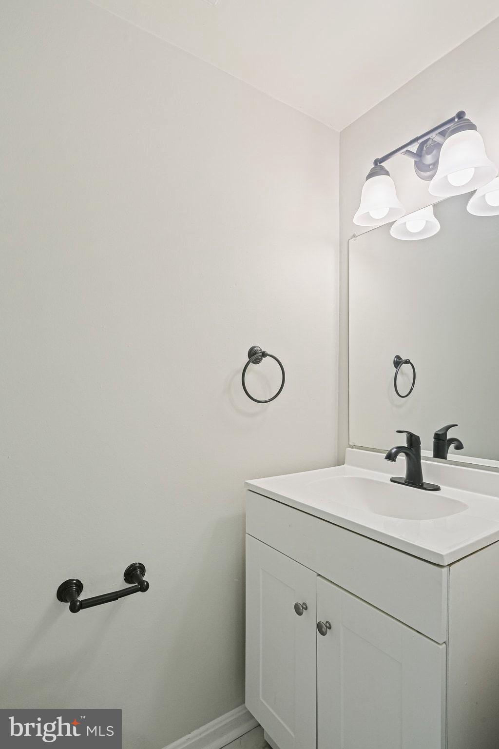 9304 Canterbury Riding, Unit 21 Laurel, MD 20723 - Photo 24 of 29 a bathroom with a sink vanity and a mirror