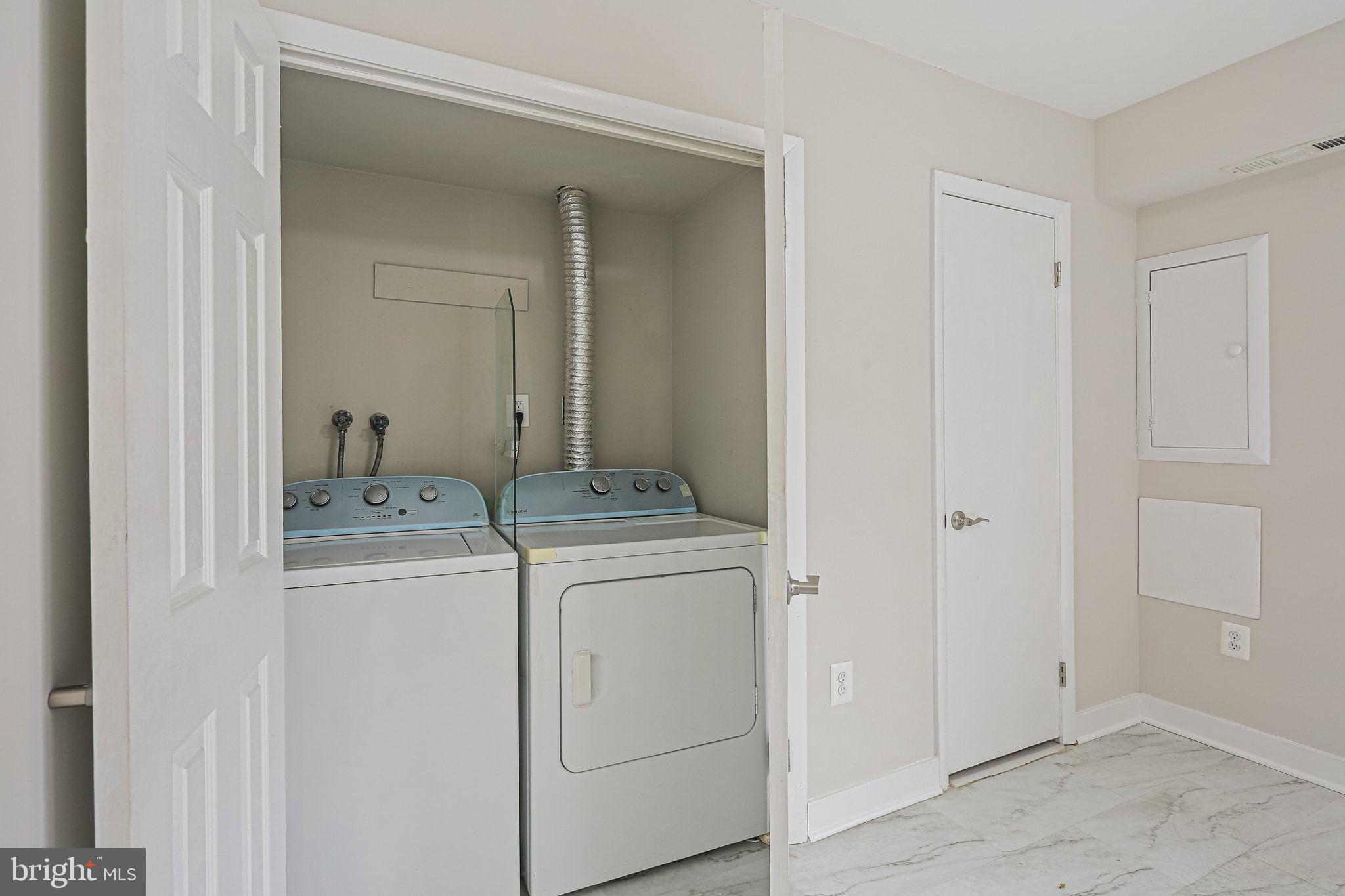 9304 Canterbury Riding, Unit 21 Laurel, MD 20723 - Photo 25 of 29 a utility room with dryer and washer