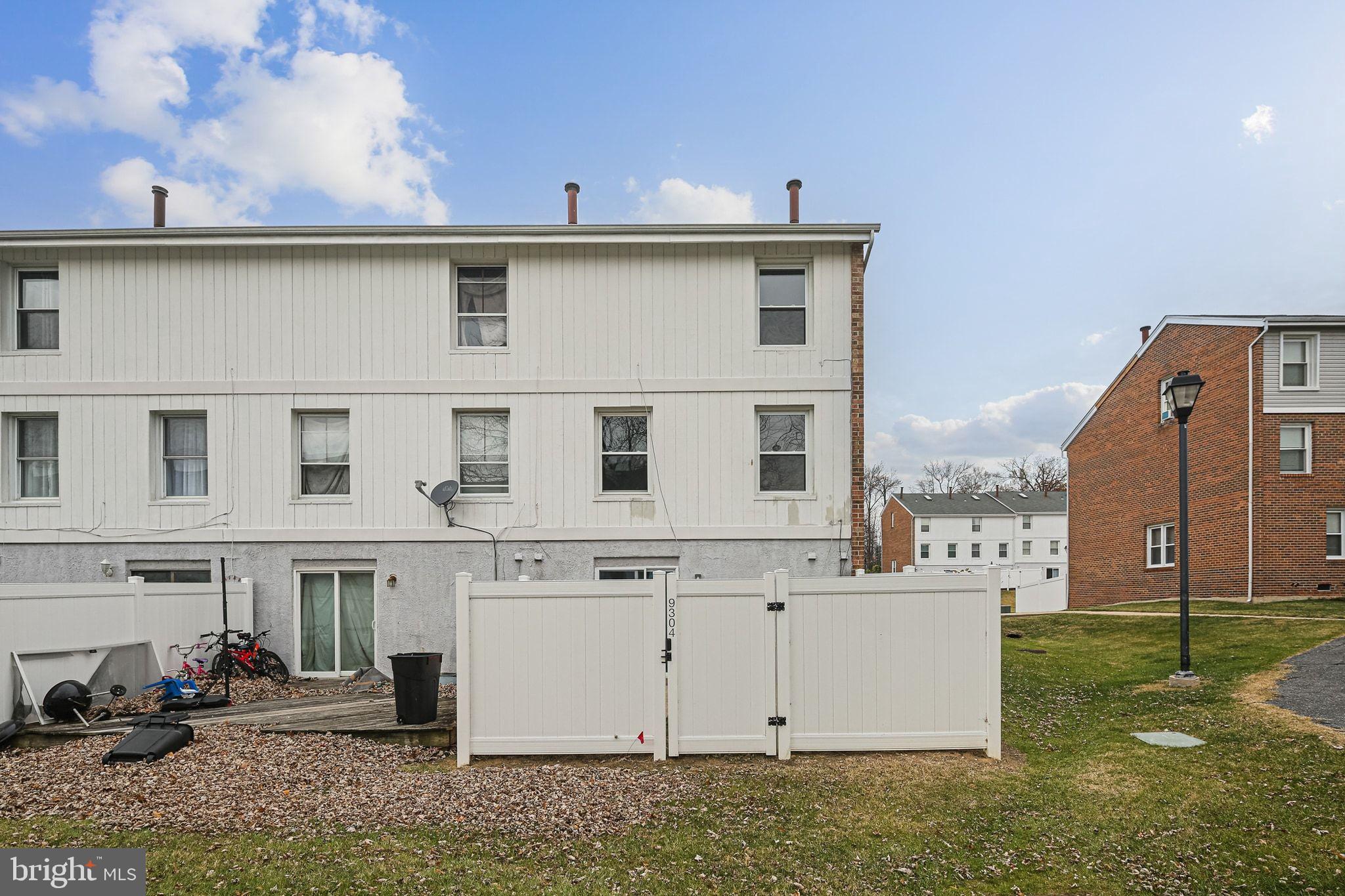 9304 Canterbury Riding, Unit 21 Laurel, MD 20723 - Photo 28 of 29 a view of a white house with large windows