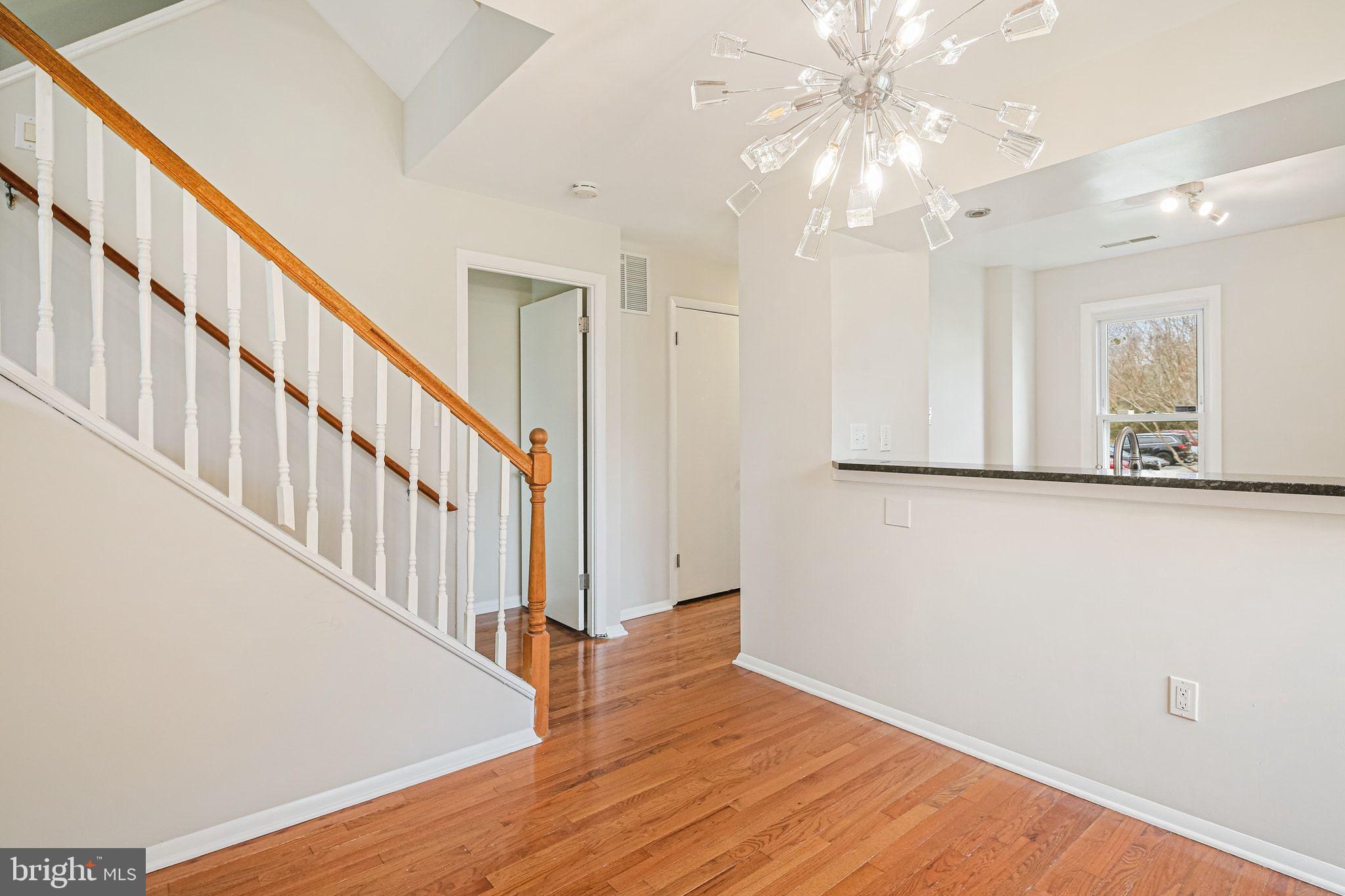 9304 Canterbury Riding, Unit 21 Laurel, MD 20723 - Photo 4 of 29 a view of a hallway with wooden floor and staircase