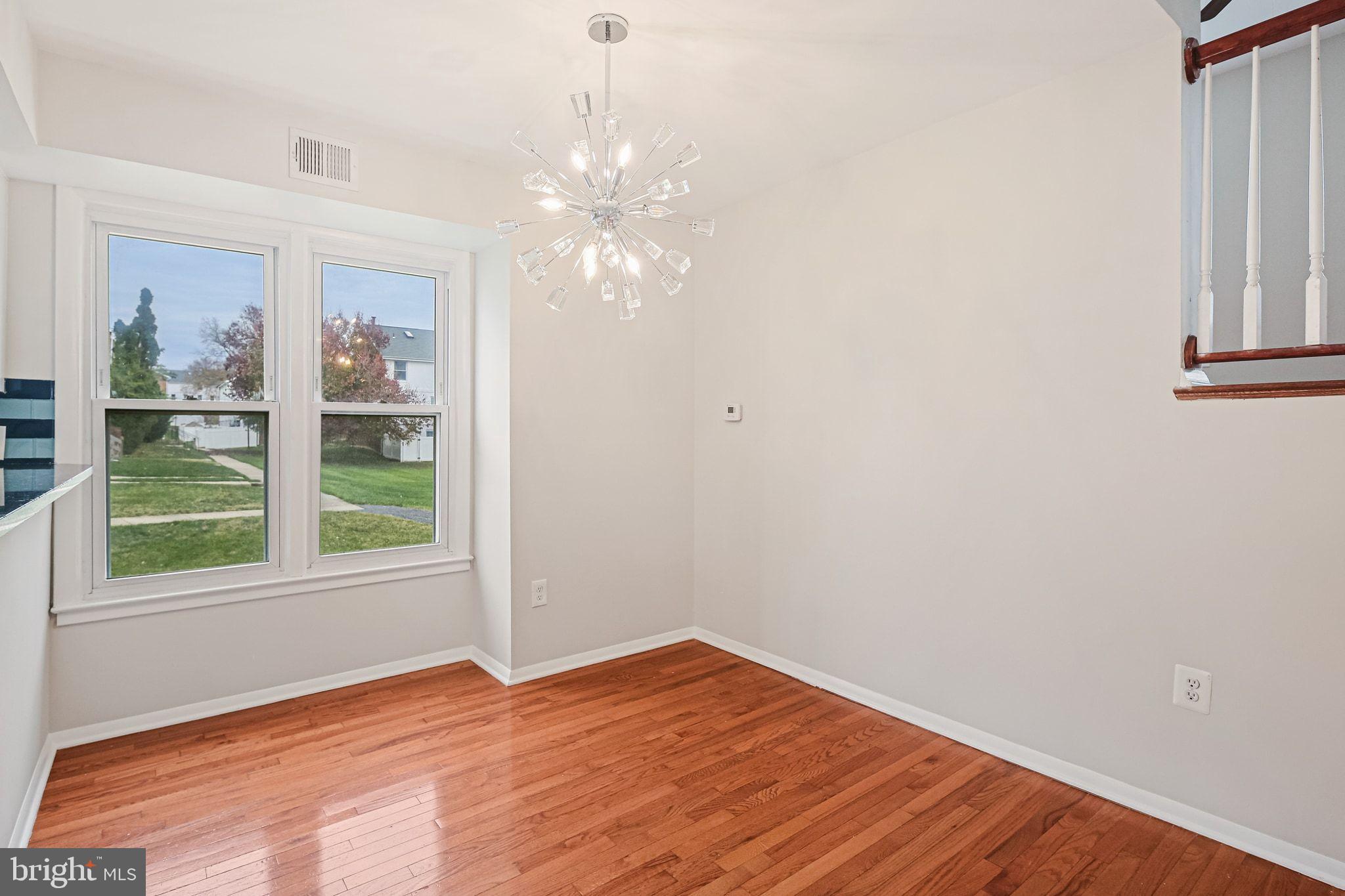 9304 Canterbury Riding, Unit 21 Laurel, MD 20723 - Photo 7 of 29 a view of empty room with wooden floor and fan