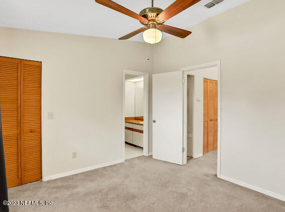 85 Debarry Avenue, Unit 1066 Orange Park, FL 32073 - Photo 13 of 24 an empty room with closet and a ceiling fan