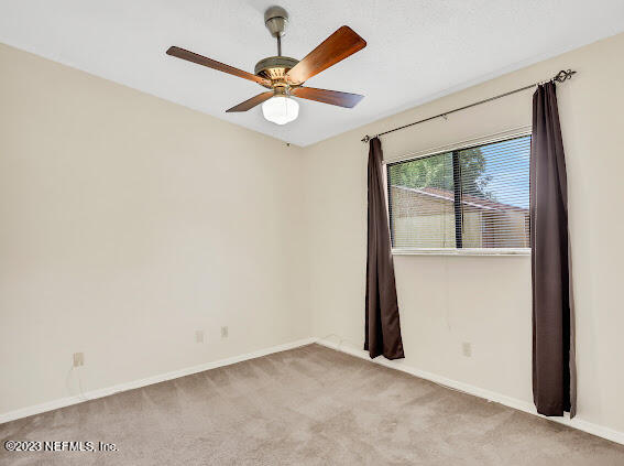 85 Debarry Avenue, Unit 1066 Orange Park, FL 32073 - Photo 14 of 24 an empty room with a window and a fan