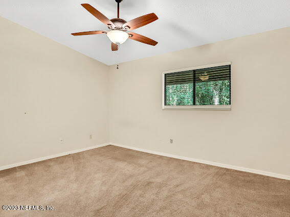85 Debarry Avenue, Unit 1066 Orange Park, FL 32073 - Photo 18 of 24 an empty room with a window and a ceiling fan