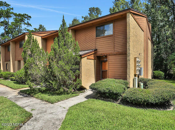 85 Debarry Avenue, Unit 1066 Orange Park, FL 32073 - Photo 2 of 24 a view of a house with yard and plants