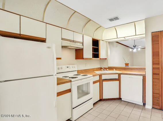 85 Debarry Avenue, Unit 1066 Orange Park, FL 32073 - Photo 9 of 24 a kitchen with stainless steel appliances granite countertop a sink a stove a refrigerator and white cabinets