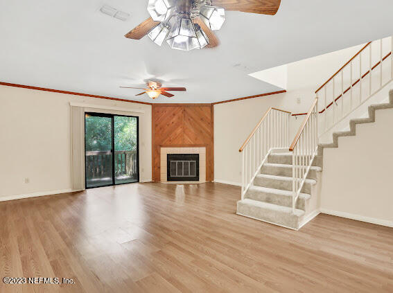 85 Debarry Avenue, Unit 1066 Orange Park, FL 32073 - Photo 10 of 24 a view of an empty room with wooden floor fireplace and a window