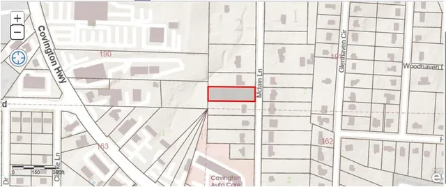 a view of a house with a lush green forest