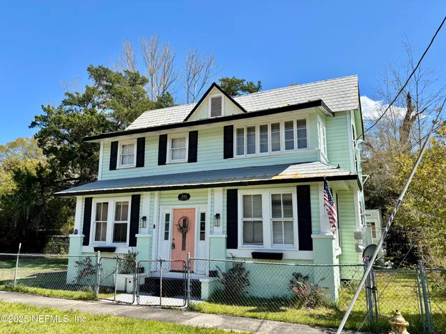 a front view of a house with a yard table and chairs