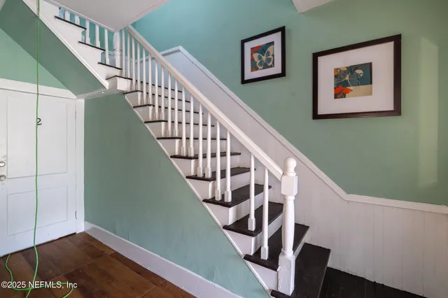 a view of a house with a big yard and potted plants
