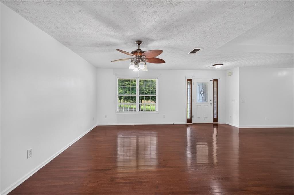602 Pendergrass Road Winder, GA 30680 - Photo 14 of 44 a view of an empty room with wooden floor and a window