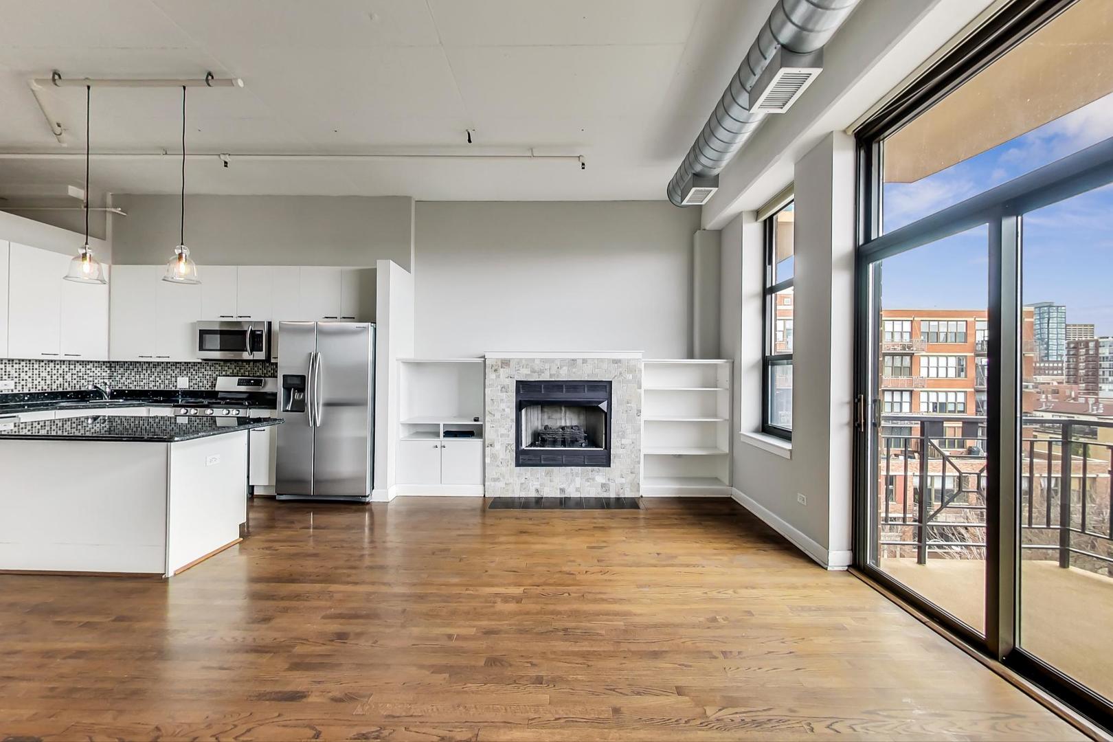 1301 West Madison Street, Unit 511 Chicago, IL 60607 - Photo 8 of 24 a large kitchen with cabinets and wooden floor