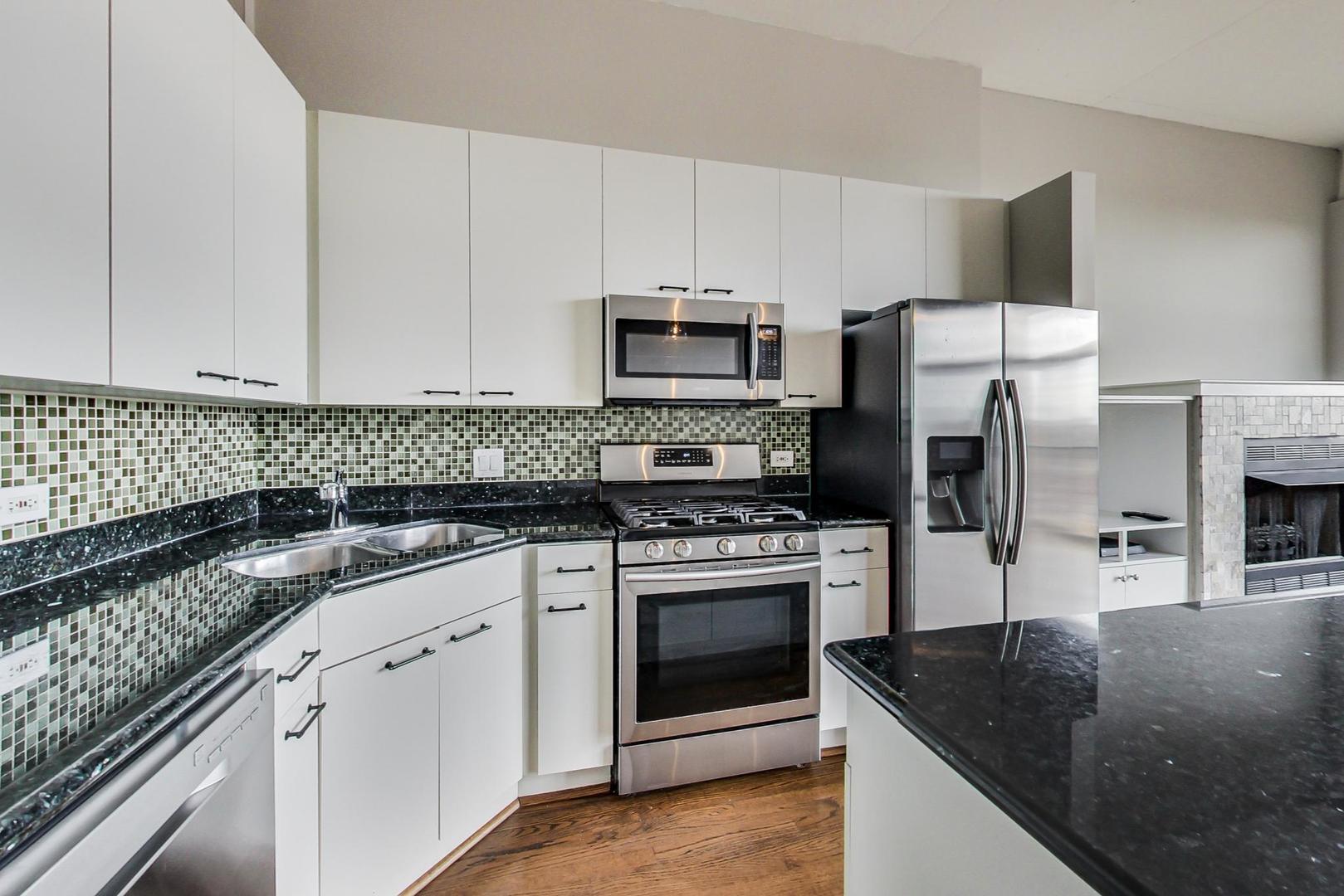 1301 West Madison Street, Unit 511 Chicago, IL 60607 - Photo 10 of 24 a kitchen with granite countertop a sink stove and refrigerator