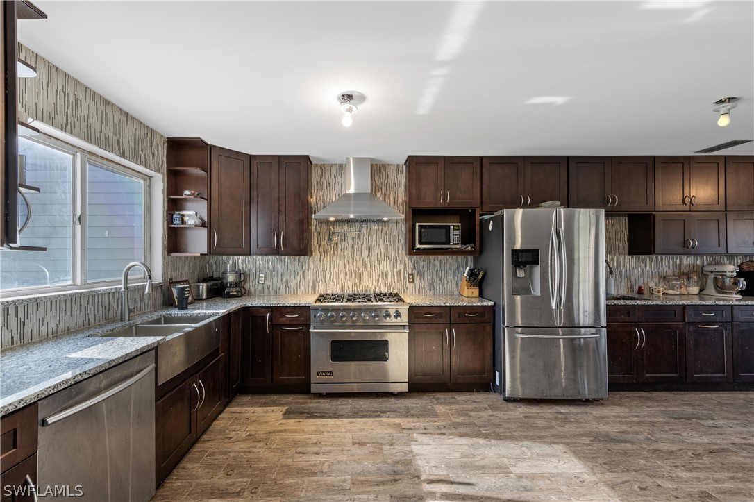 785 Rabbit Road Sanibel, FL 33957 - Photo 1 of 20 a kitchen with stainless steel appliances granite countertop a stove top oven a sink and a refrigerator