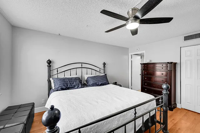 a bedroom with a bed and a ceiling fan