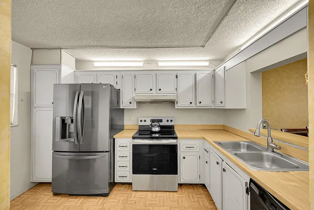 a kitchen with a sink stove and refrigerator