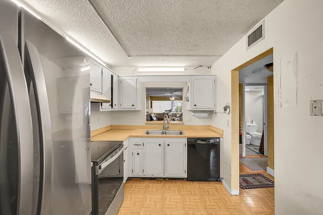 a kitchen with a sink stove and refrigerator