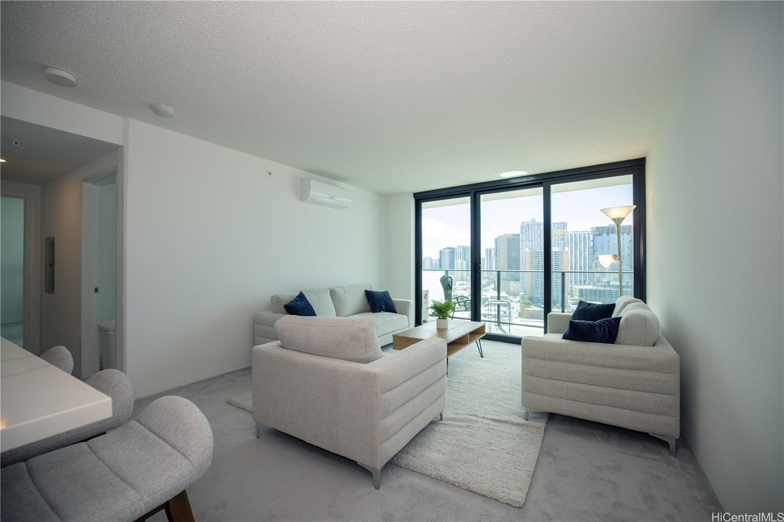 615 Keawe Street, Unit 2408 Honolulu, HI 96813 - Photo 6 of 16 a living room with furniture and a large window