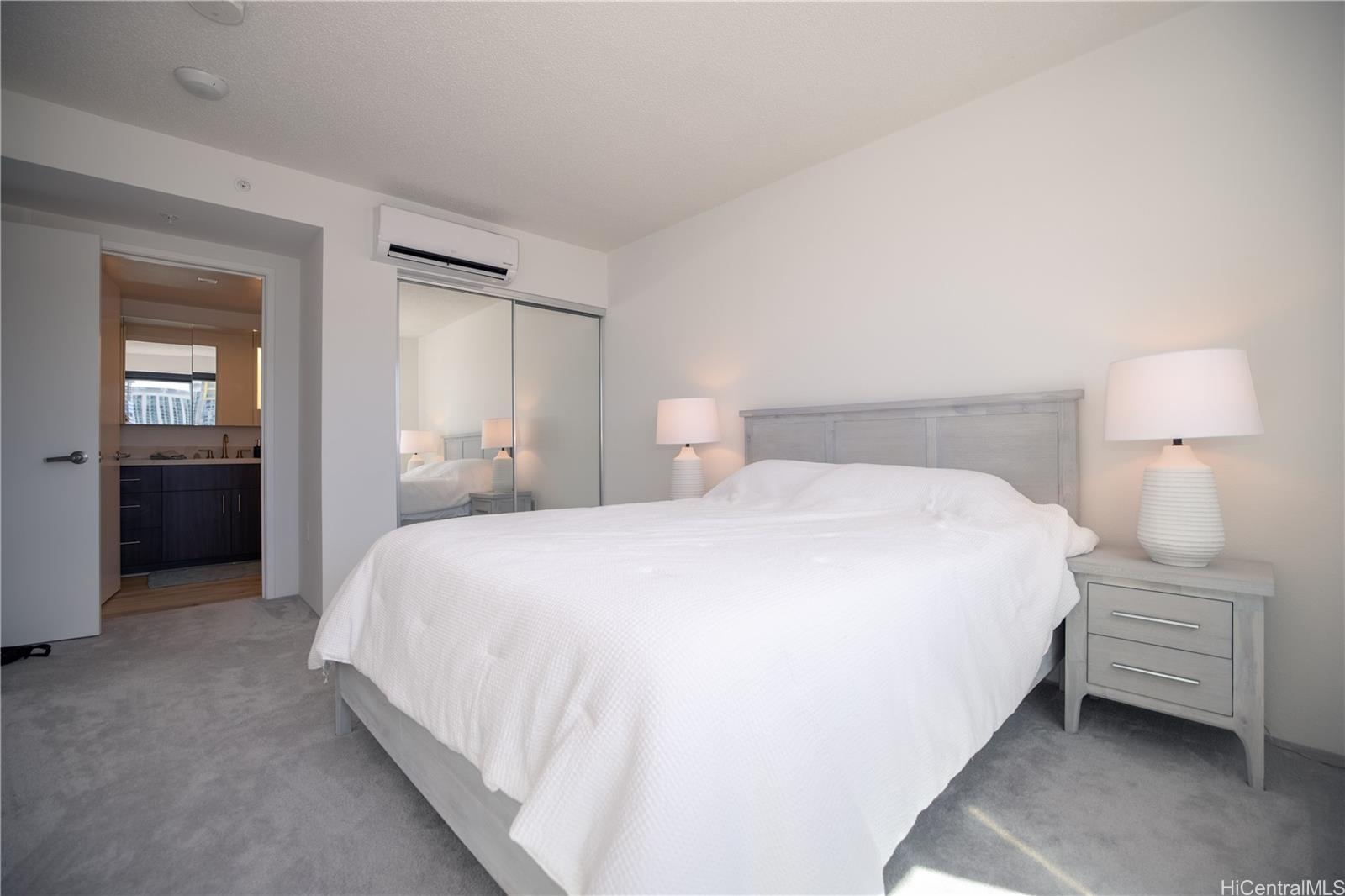 615 Keawe Street, Unit 2408 Honolulu, HI 96813 - Photo 7 of 16 a bedroom with a bed and a night stand