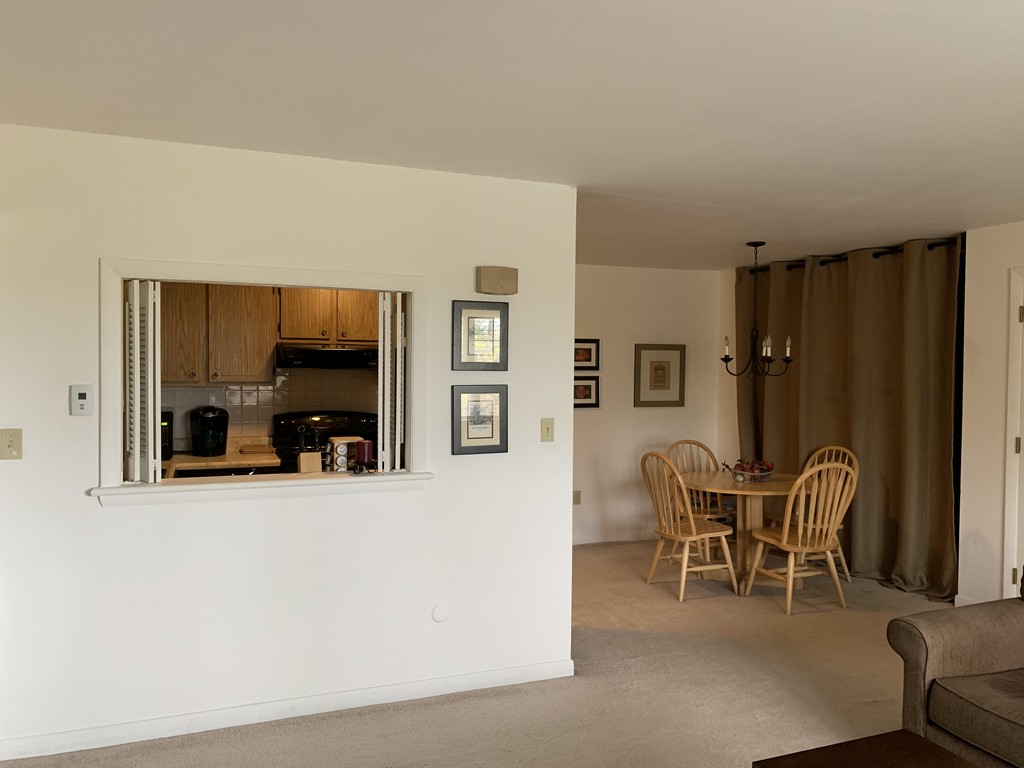 64 Jacqueline Road, Unit 12 Waltham, MA 02452 - Photo 11 of 16 a living room with furniture and a large window
