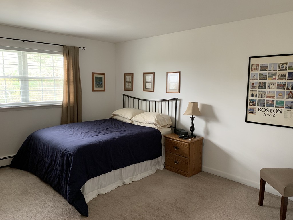 64 Jacqueline Road, Unit 12 Waltham, MA 02452 - Photo 13 of 16 a bedroom with a bed next to a window