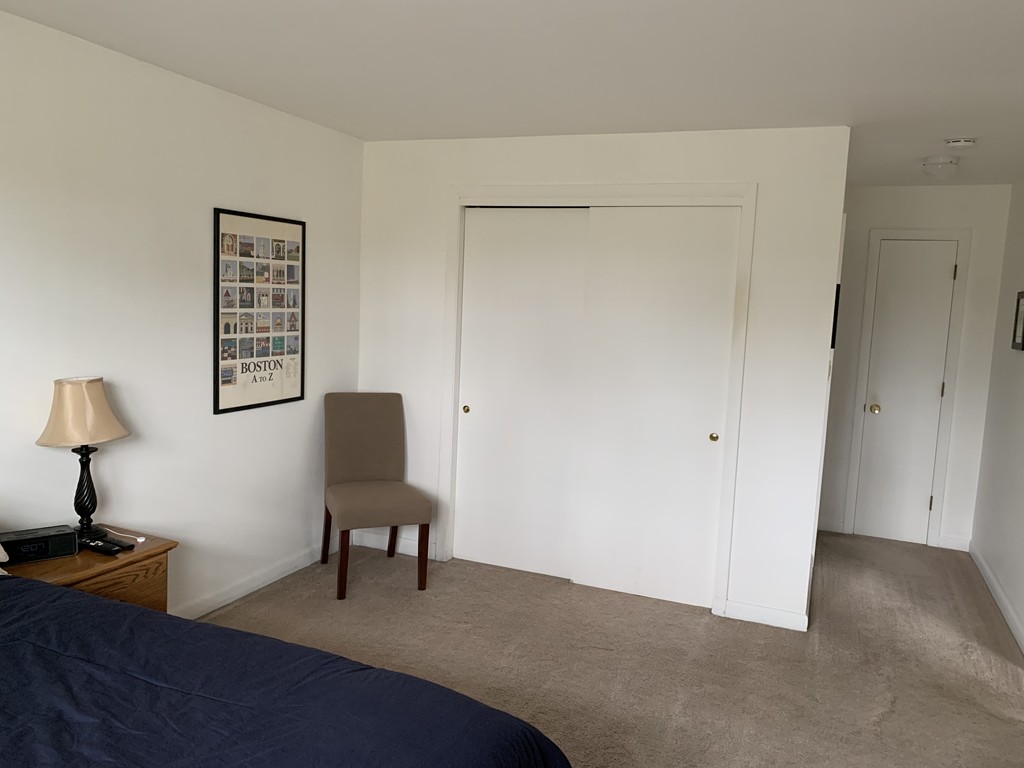 64 Jacqueline Road, Unit 12 Waltham, MA 02452 - Photo 14 of 16 a view of a livingroom with furniture and a lamp