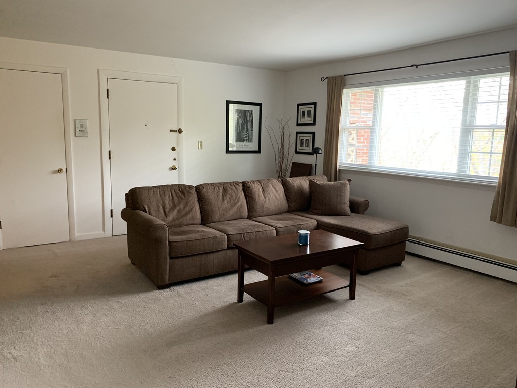 64 Jacqueline Road, Unit 12 Waltham, MA 02452 - Photo 5 of 16 a living room with furniture and a window