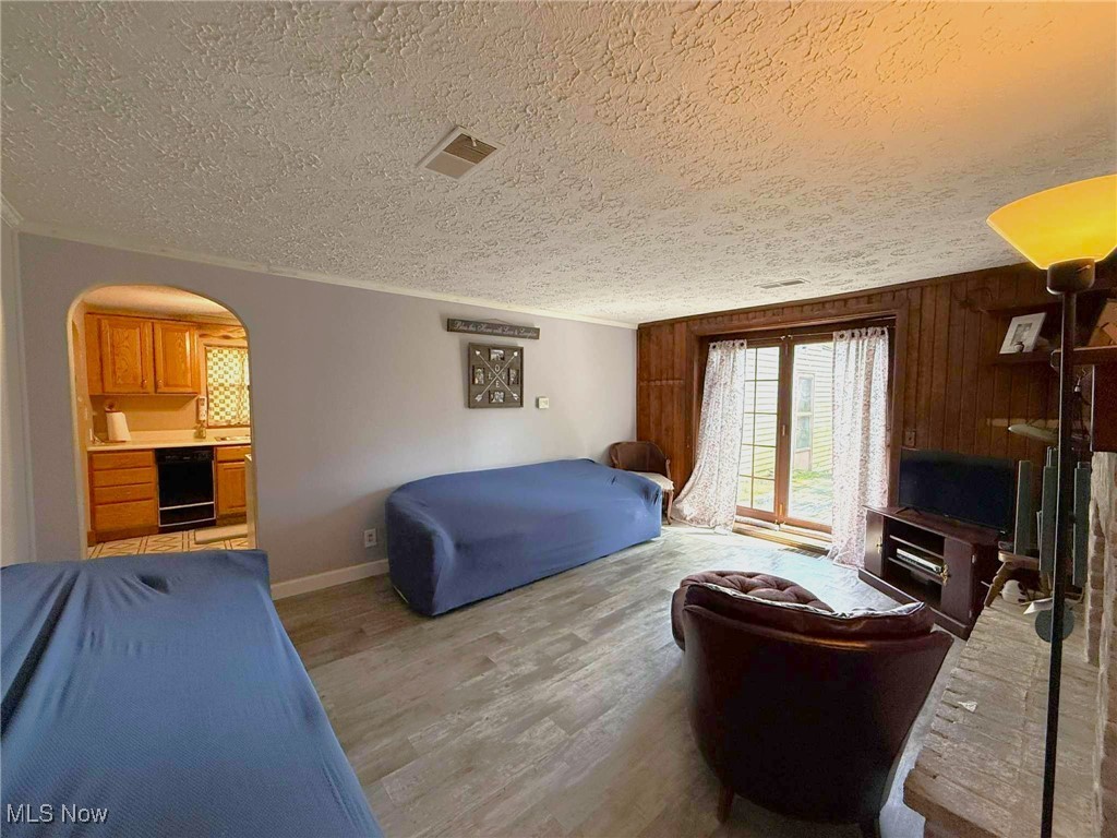 406 Johnson Plank Road Warren, OH 44481 - Photo 6 of 17 Living room with vinyl plank flooring and a wood burning fireplace
