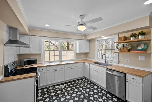 a kitchen with a sink stove and cabinets