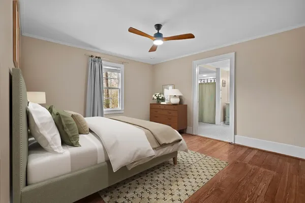 a bedroom with a large bed and a window