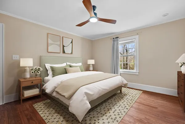 a bedroom with bed and wooden floor