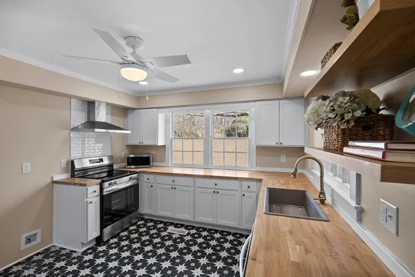 a kitchen with a sink stove and cabinets