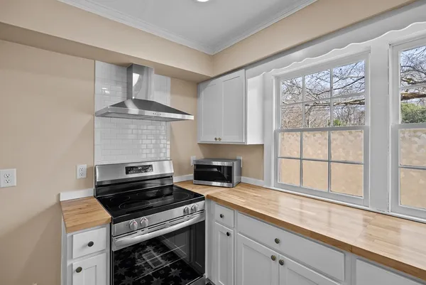 a kitchen with granite countertop a stove and a sink