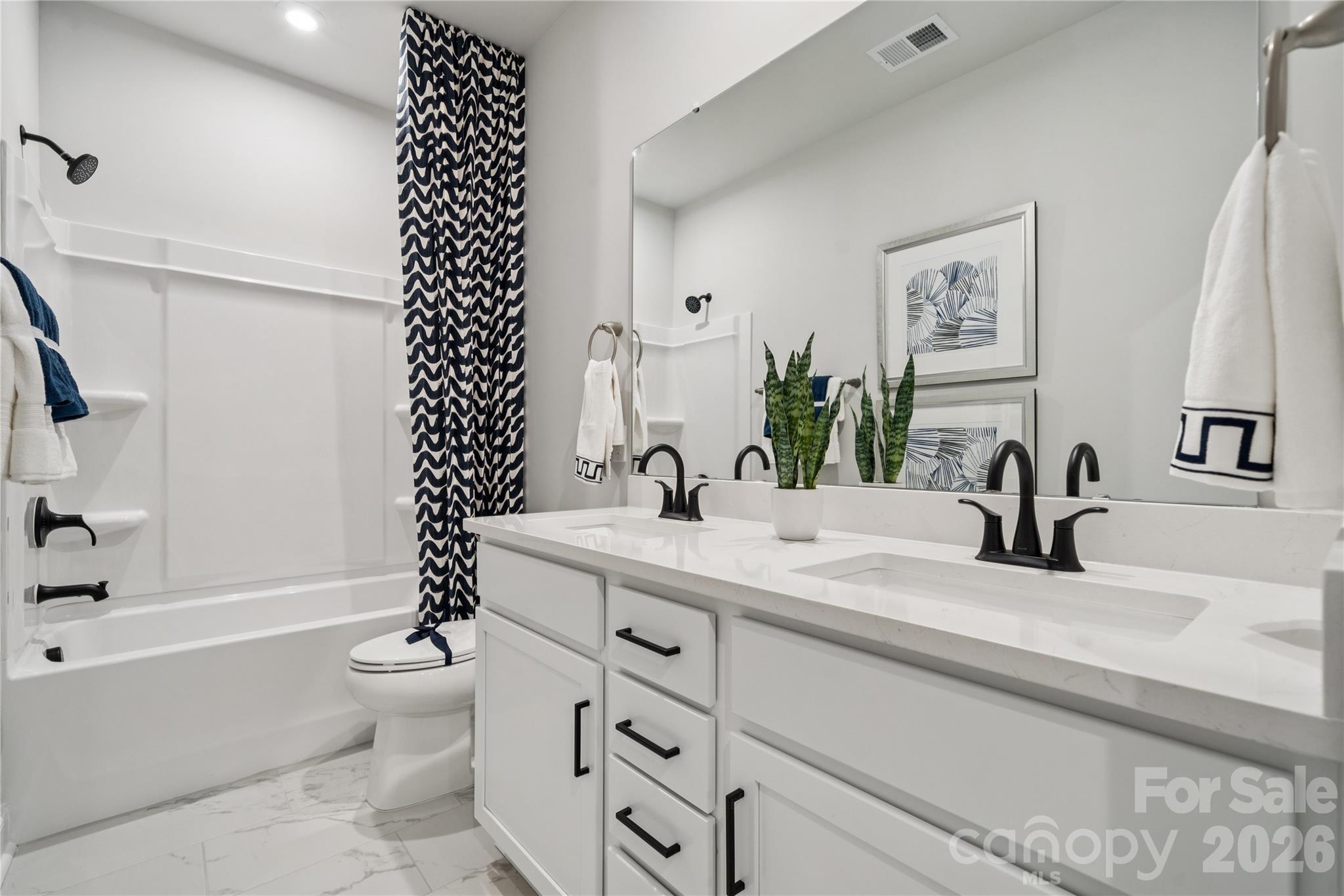 1293 Margo Mannor None Fort Mill Fort Mill, SC 29708 - Photo 14 of 32 a bathroom with a double vanity sink toilet and shower