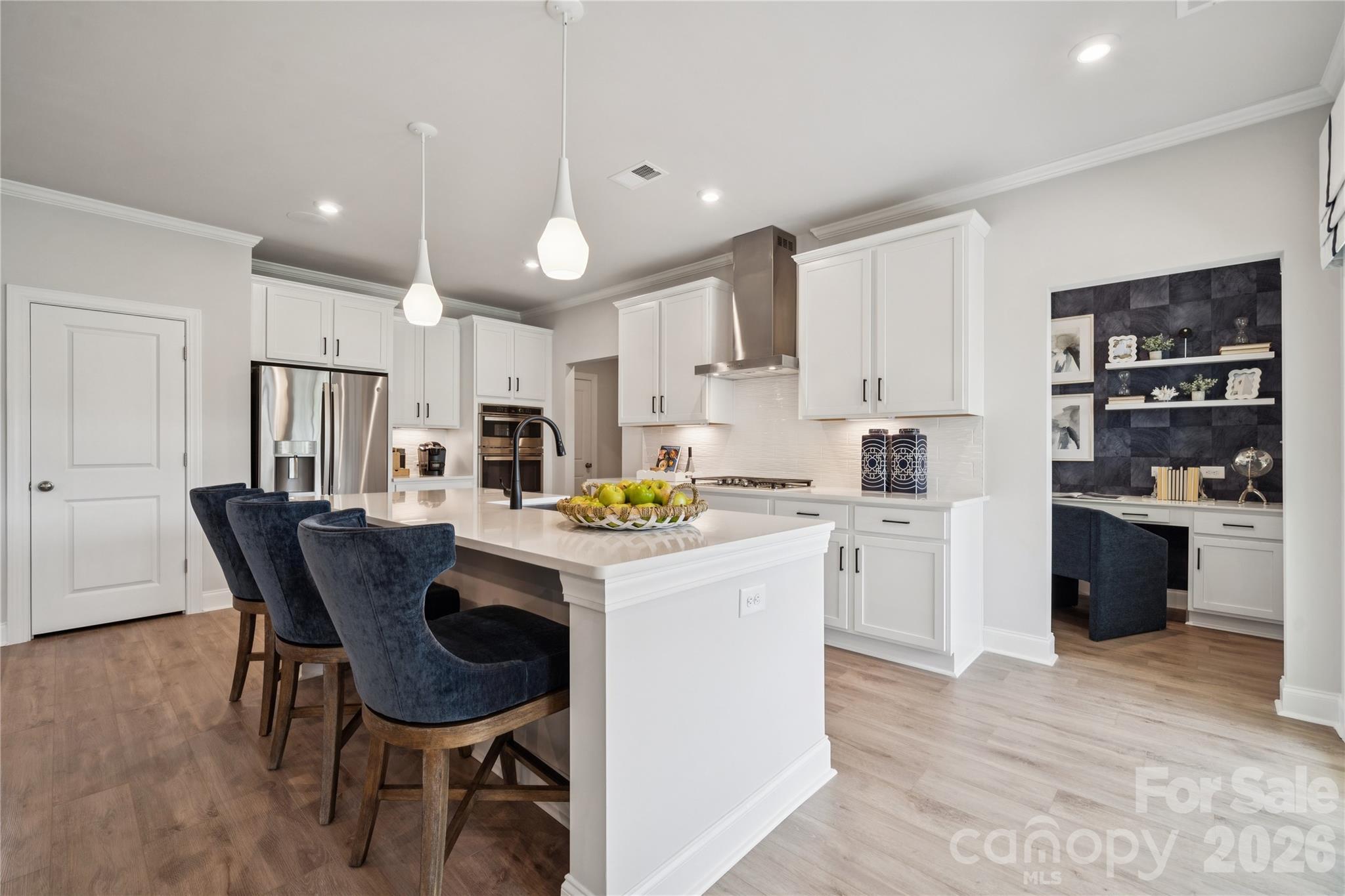 1293 Margo Mannor None Fort Mill Fort Mill, SC 29708 - Photo 10 of 32 a kitchen with kitchen island a stove a table and chairs
