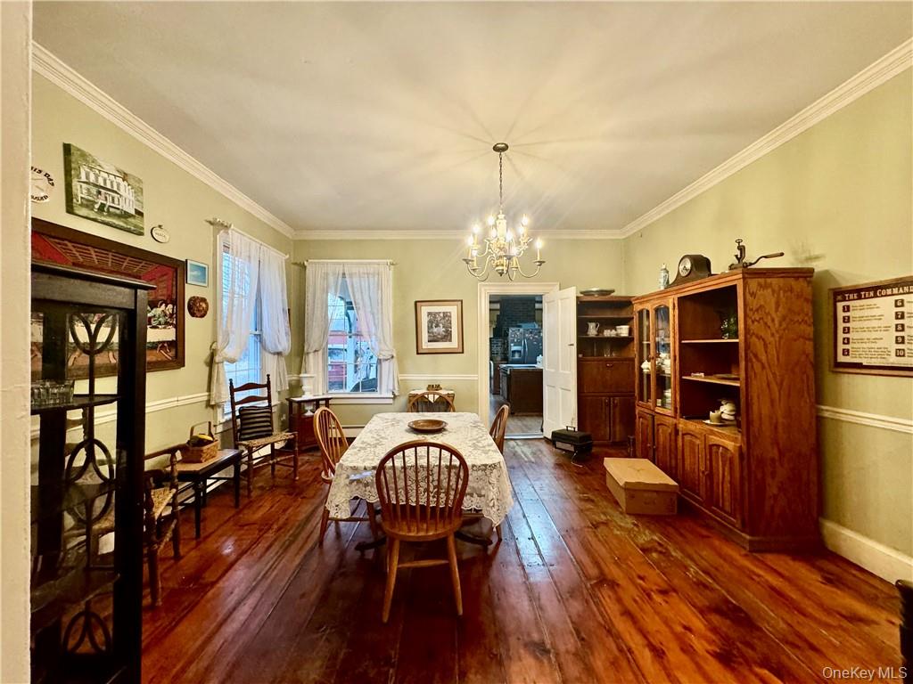 255 Howells Road Middletown, NY 10940 - Photo 11 of 38 a living room with furniture a chandelier and a dining table
