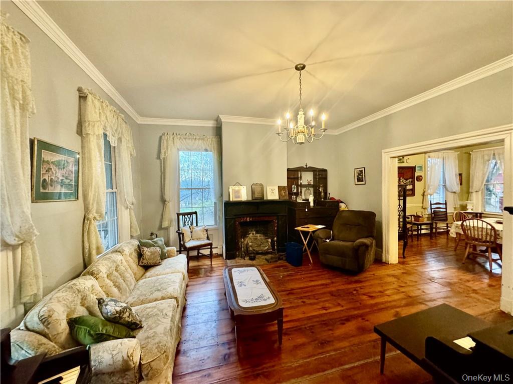255 Howells Road Middletown, NY 10940 - Photo 14 of 38 a living room with furniture and a chandelier