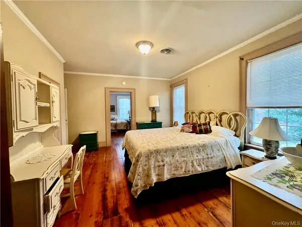 a bed room with a bed and two couches chair