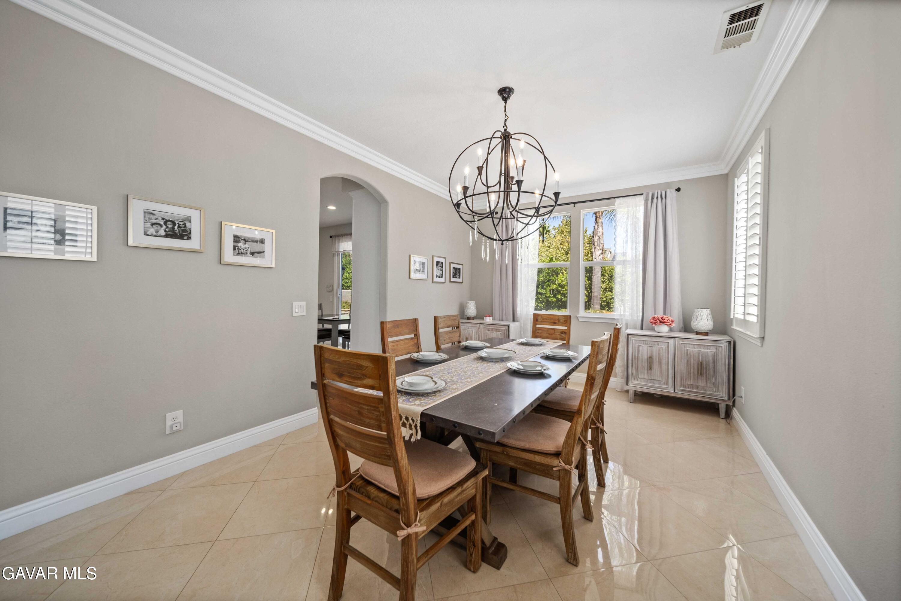26505 Thackery Lane Stevenson Ranch, CA 91381 - Photo 12 of 63 a view of a dining room with furniture window and chandelier