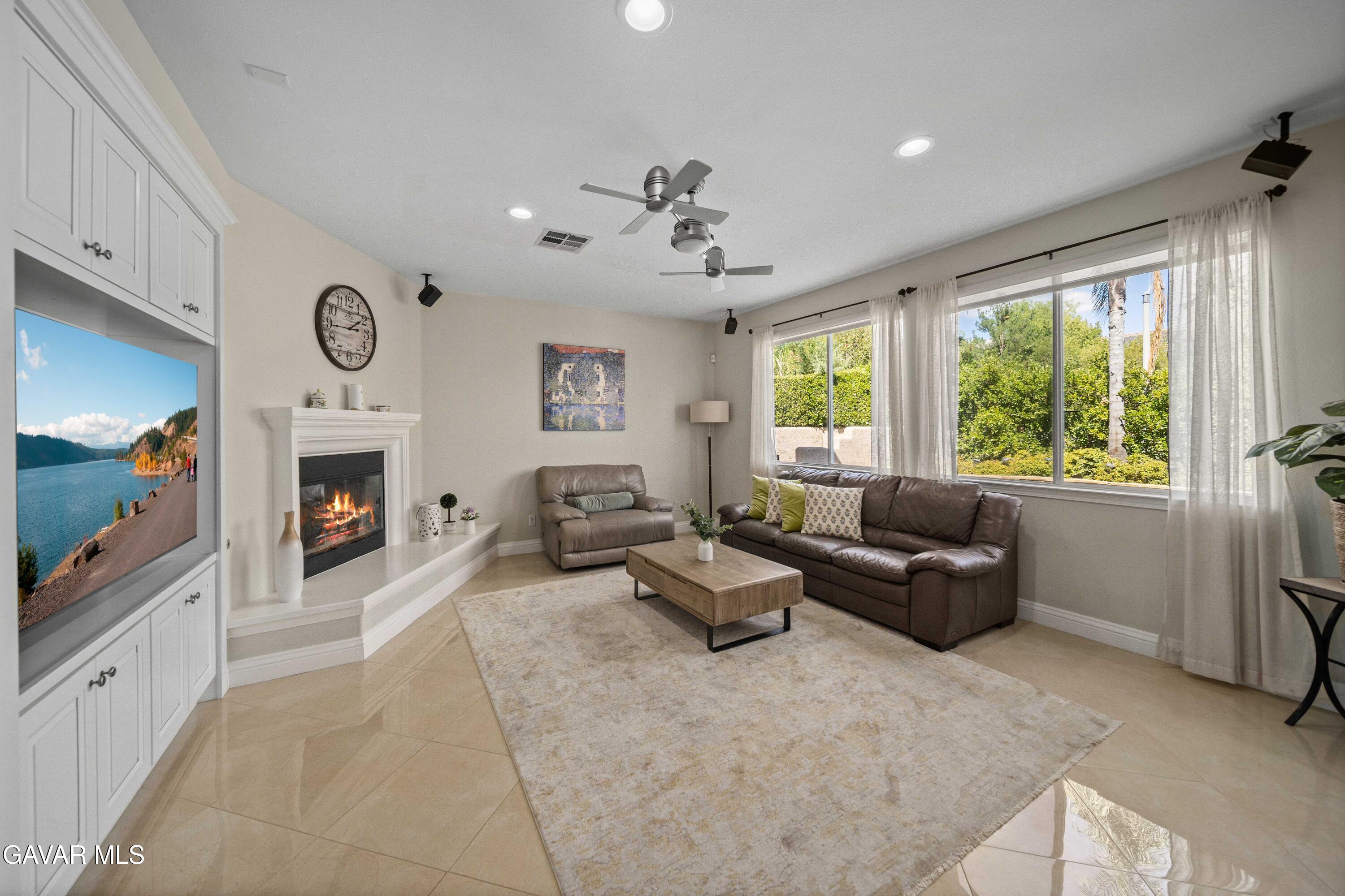 26505 Thackery Lane Stevenson Ranch, CA 91381 - Photo 19 of 63 a living room with furniture large window and a fireplace
