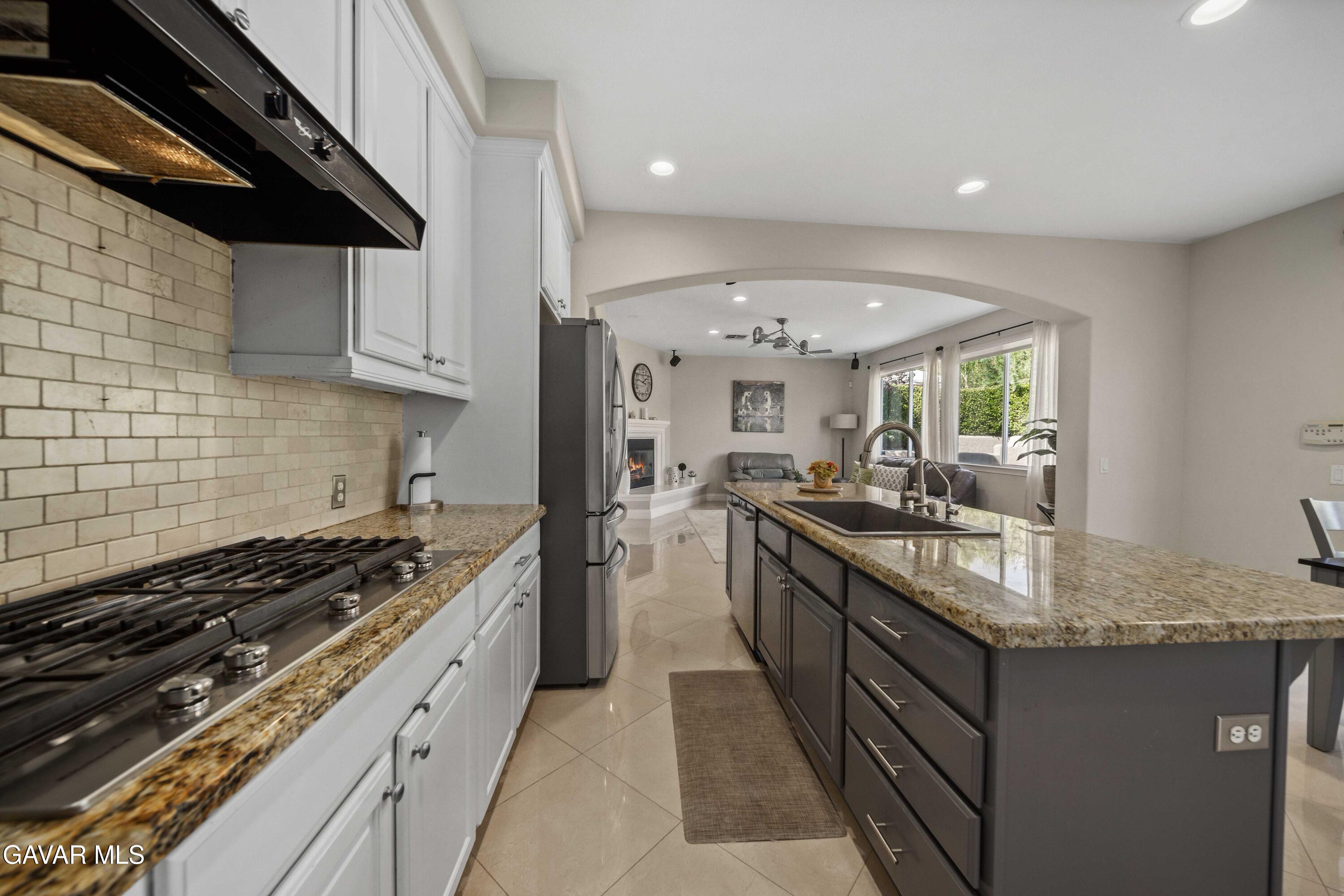 26505 Thackery Lane Stevenson Ranch, CA 91381 - Photo 25 of 63 a kitchen with granite countertop stainless steel appliances lots of counter top space