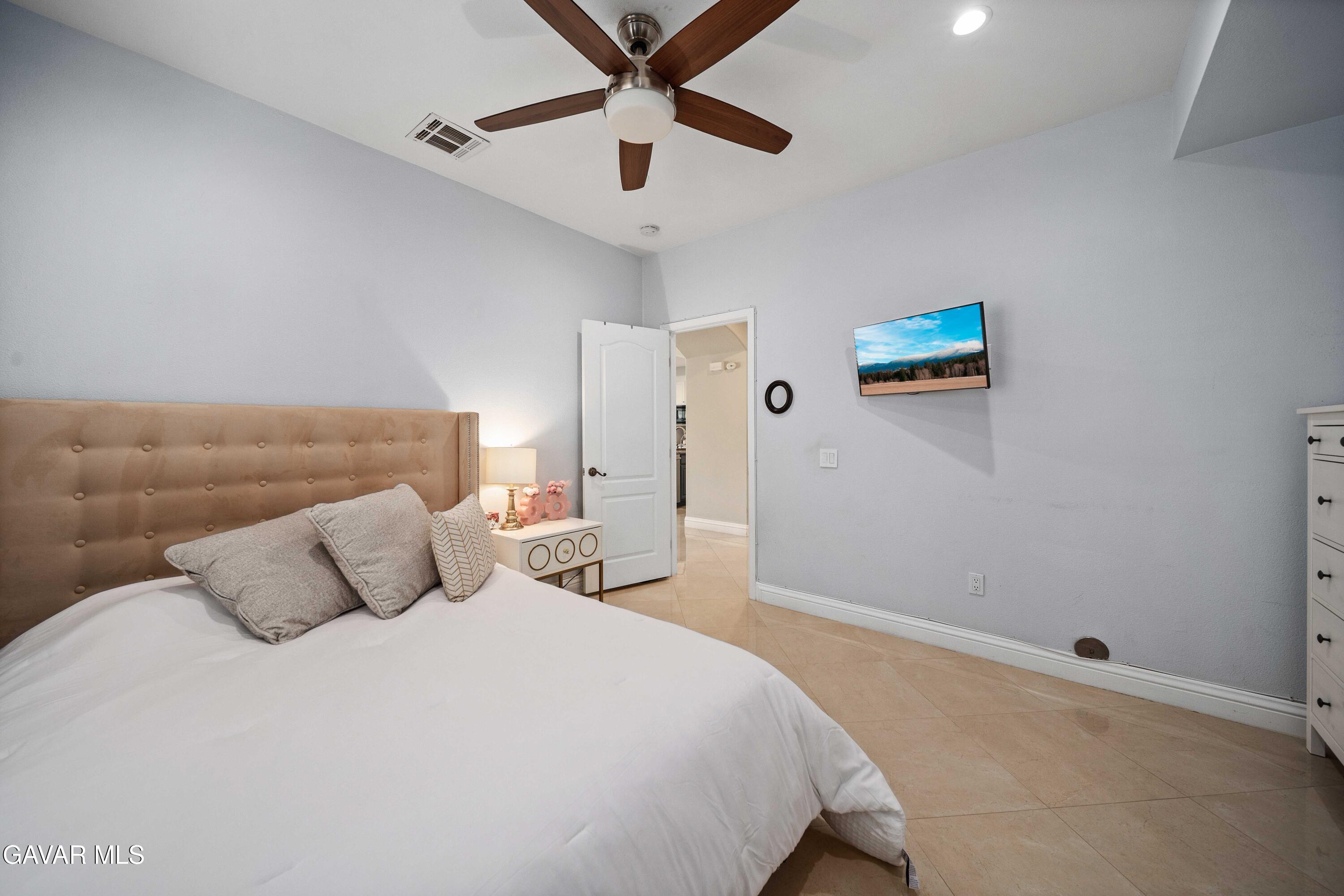 26505 Thackery Lane Stevenson Ranch, CA 91381 - Photo 31 of 63 a bedroom with a bed and a ceiling fan