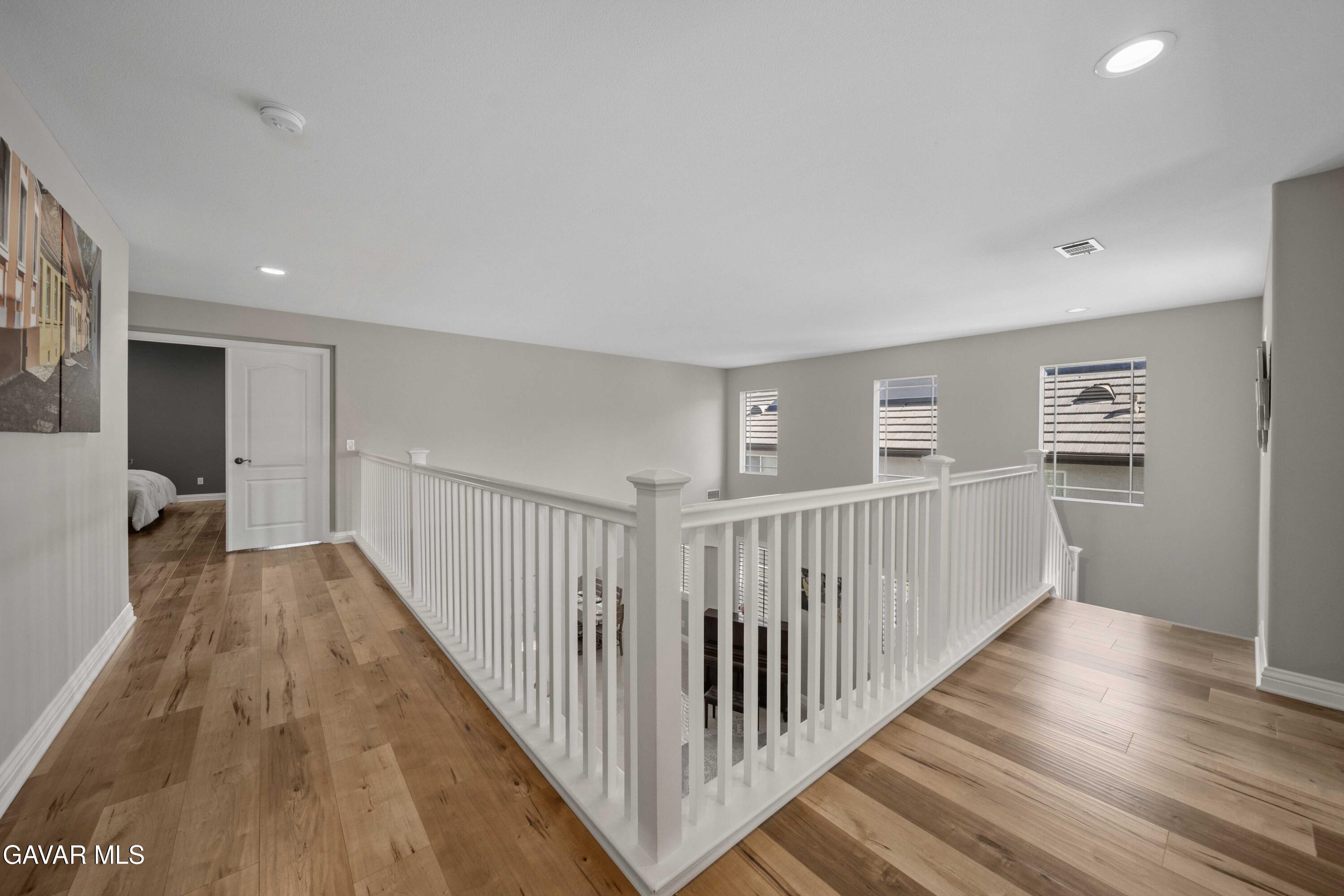 26505 Thackery Lane Stevenson Ranch, CA 91381 - Photo 34 of 63 a view of a hallway with closet and wooden floor